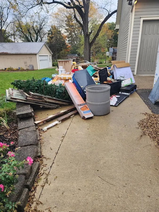 Dumpster being loaded with debris for Estate Cleanout Dumpster Rental in Fort Fairfield